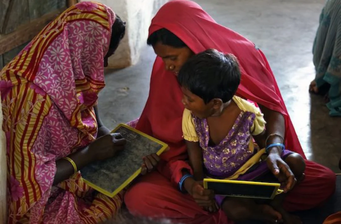 Women standing together during a community program