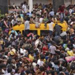 Devotees sit atop a vehicle as people crowd to attend the Maha Pushkaralu, a Hindu festival, near the banks of river Godavari at Rajahmundry in Andhra Pradesh, India, July 14, 2015. Twenty-seven people were killed and 40 injured on Tuesday in a stampede, police said, as crowds surged to bathe in the Godavari River on the first day of the religious festival held once every 144 years. REUTERS/R Narendra - RTX1K9LP